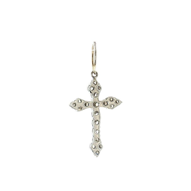 A late 20th-century 14k gold diamond cross pendant. Features brilliant cut white diamonds. Slightly included clarity,...