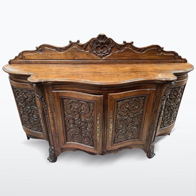 An impressive late Baroque cabinet crafted from solid oak, dating to the late 18th century. Richly carved floral and...