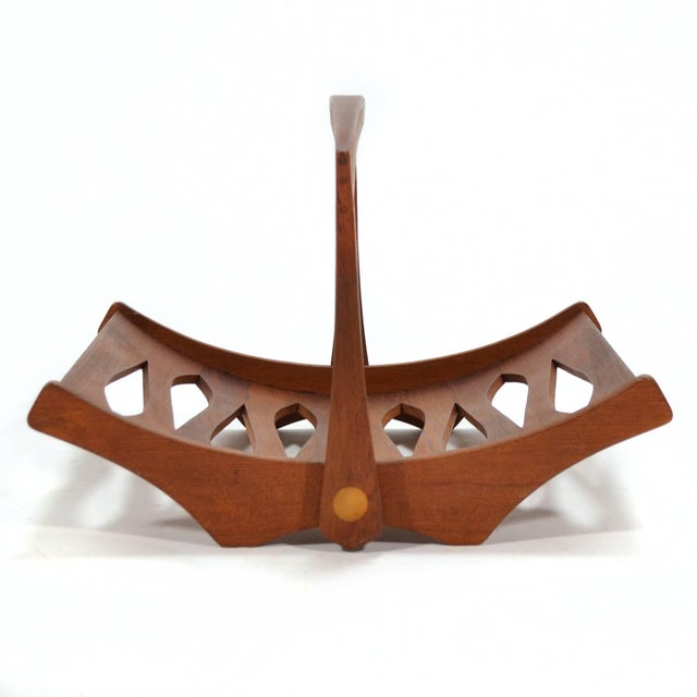 This teak magazine holder by Jens Quistgaard is both very beautiful and impeccably crafted. The sculptural form is elegant...