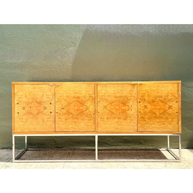 Elevated by a sleek chrome stretcher base, this 1960s mid-century modern credenza from Bernhardt's "Flair" collection...