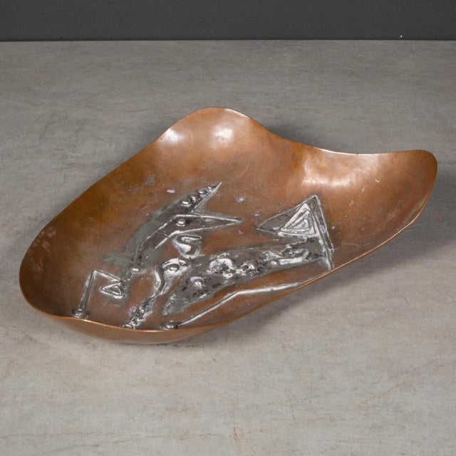 ABOUT A mid-century kidney shaped copper trinket dish with silver applique. Stamped "Chevez" CREATOR Chevez. DATE OF...