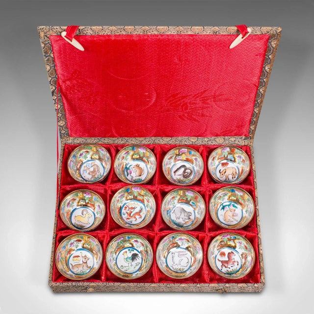 This is a set of vintage zodiac cups. A Chinese, ceramic miniature dish displaying the lunar calendar of animal signs,...