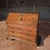Antique walnut writing desk featuring rocaille bronze accents and an internal compartment.