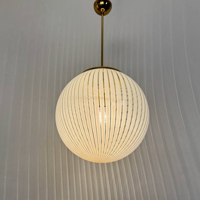Murano Tessuto Globe Pendant Lamp by Venini, 1980s, in Flawless conditions. Designed 1960 to 1969 This piece is attributed...
