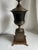 Vintage Mid 20th Century Neoclassical or Hollywood Regency Style black urn on footed pedestal brass and bronze lamp with...