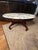 Elegant vintage oval marble-top coffee table featuring a beautifully carved floral and leaf apron, classic cabriole legs,...