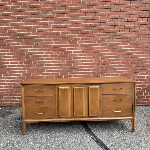 Part of Broyhill’s Forward collection, this vintage lowboy dresser features a long walnut case with clean lines, softly...