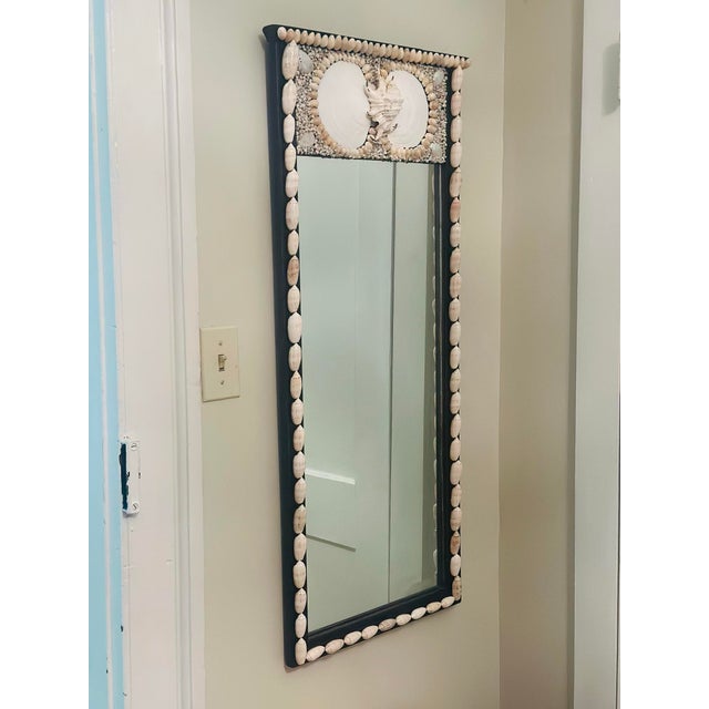 This vintage wooden mirror is embellished with beautiful shells. Neutral in color, great tall narrow size, this is a good...