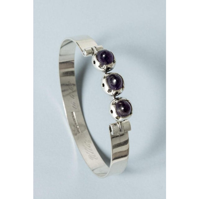 Lovely silver bracelet by Martti Viikinniemi, with a row of elevated, cabochon cut amethyst stones. Cool design that...
