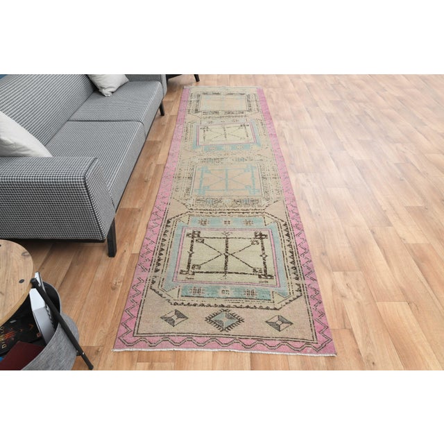 Vintage Hand-Knotted runner rug is a semi-antique vintage area rug. The '70s Eastern region of Anatolia's unique rug is...