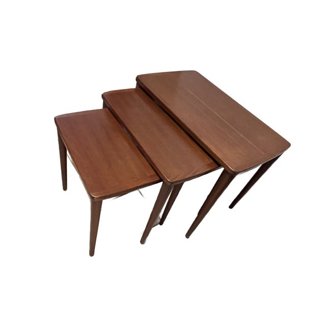 The three nesting tables are mid century modern from Denmark. They are made of solid teak, rectangular in form with...