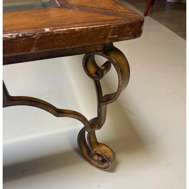 Vintage leather, iron, and glass top square coffee table attributed to Thomasville.. The table features an embossed...