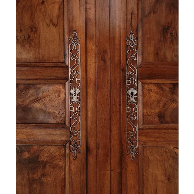 A pair of walnut Louis XVI doors, France, 18th century. Great old hardware. The total width of the two doors together is...