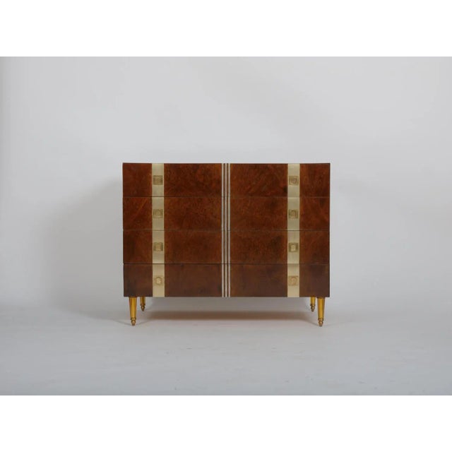 Burr wood, four drawers, with inlaid brass and aluminium elements. Golden glass and gilt brass feet Brass pulls to drawers