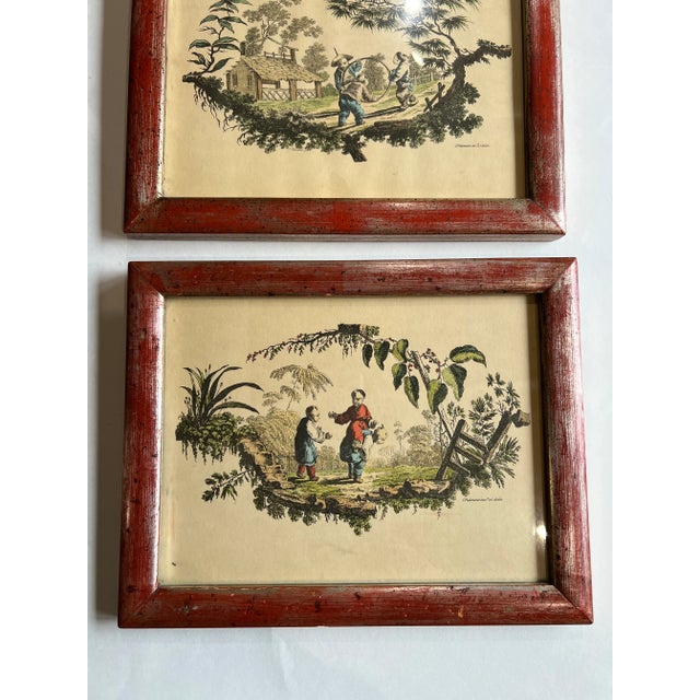Sensation pair of framed prints of Asian scenes. Typical toile designed on parchment colored paper, hand colored. Solid...