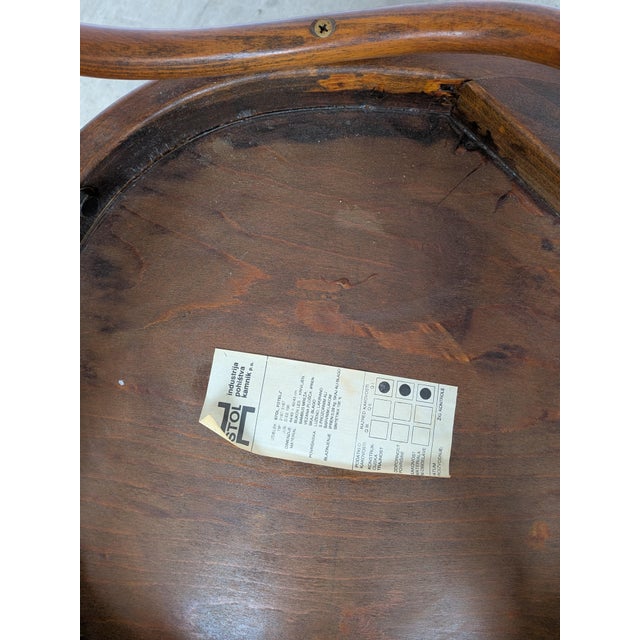 Vintage bentwood dining chair made in the Thonet style. The chair features a curved bentwood frame and an engraved...