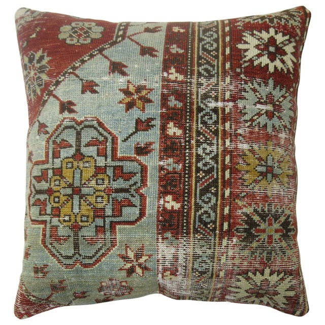 Pillow made from a 19th century distressed Caucasian rug in blues and red Measures: 20" x 20".