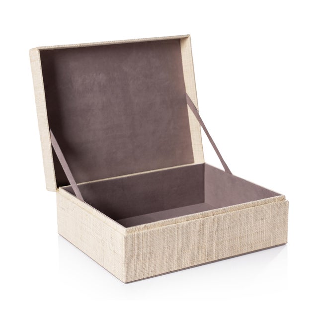 A beautifully handcrafted decorative box, this piece is made from chipboard wrapped in fine natural raffia fabric with...
