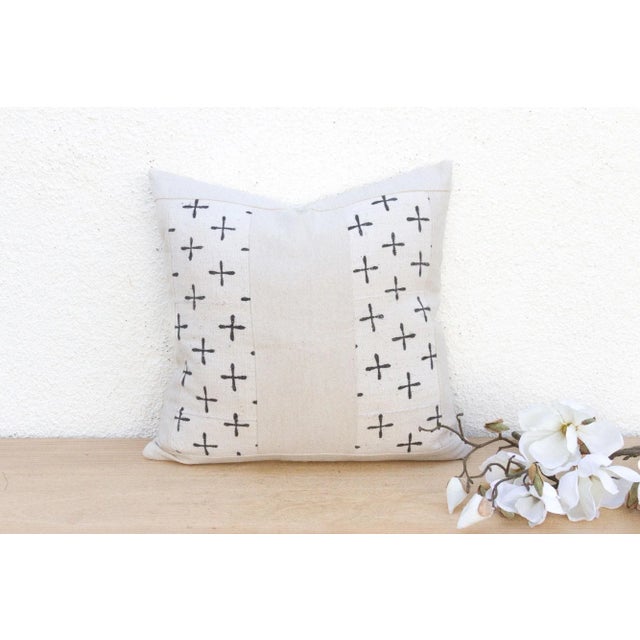 This striking decorative pillow is a profound example of how simple form can carry powerful meaning. This 16-inch square...