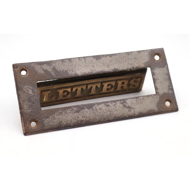 Vintage spring loaded mail slot that opens inward at 45 degrees to allow mail through. Made of a cast iron frame with a...