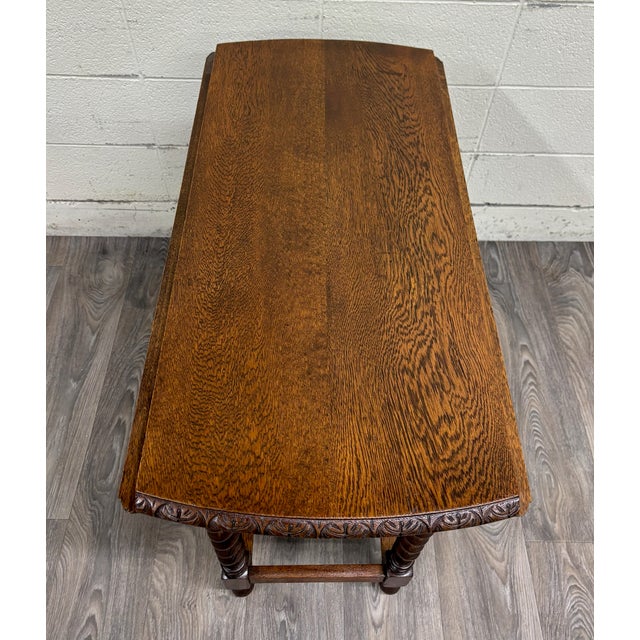 This is a stunning antique late 19th century English or American Jacobean Revival drop leaf gate leg dining table or side...