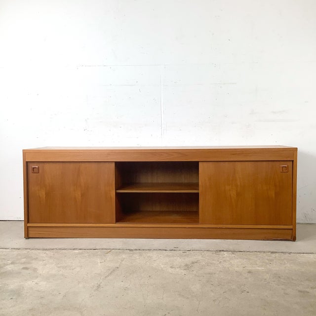 This vintage Scandinavian Modern credenza embodies the restrained elegance and functional design principles that have made...