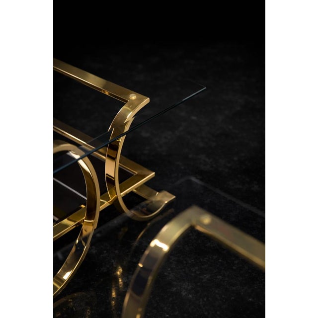 This pair of glass tables was produced in Italy during the 1960s. The upper glass is transparent and the lower glass is...