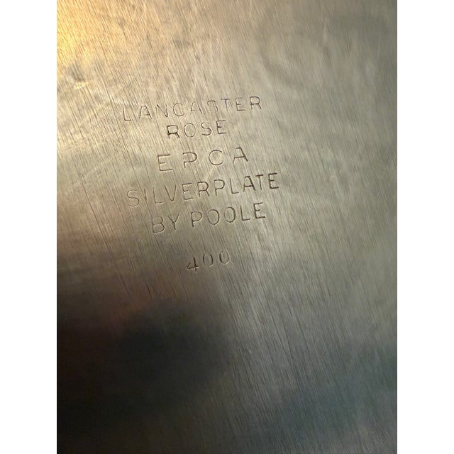 A large, footed silverplate serving tray in Poole Silver Co.'s Lancaster Rose pattern (EPCA #400) — a rose-motif design...