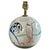 Hand-painted golfers, a caddy and golf bags wrap around the spherical body of this Gray’s Pottery lamp. The cream glaze...