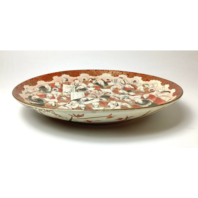 Large 15" in diameter Kutani Million Faces Porcelain Platter 19th Century. Age appropriate condition with a mark on the...