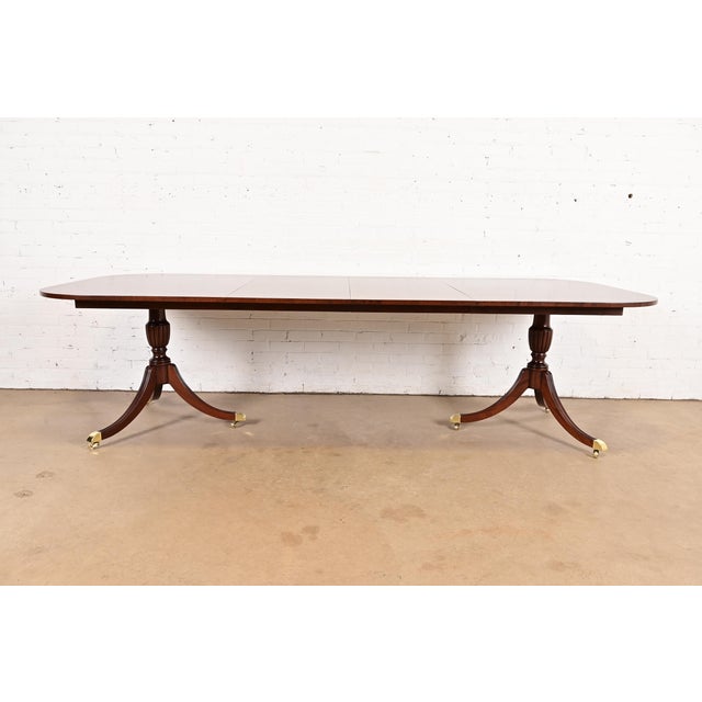 An exceptional Georgian or Regency style double pedestal extension dining table By Councill Furniture USA, Circa 1980s...
