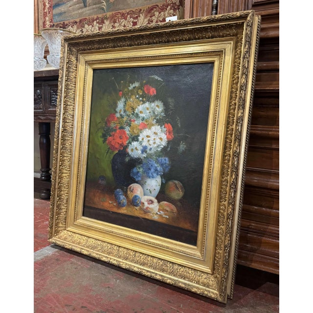Bursting with color and intricate detail, this antique French oil on canvas painting depicts a vibrant floral still life...