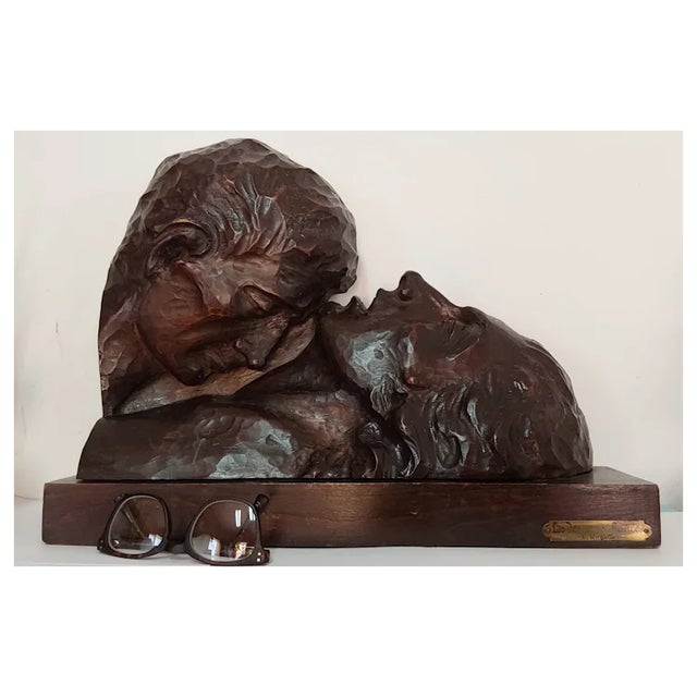 A vintage hand carved Sculpture depicting Lovers. The Sculpture is carved from wood and is titled and signed "Les Deux bux...