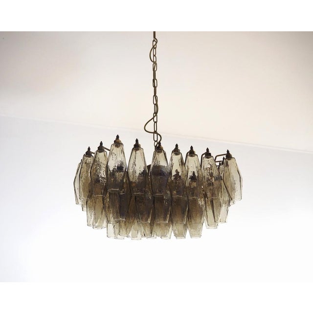 Elegant italian chandelier made from 56 beautiful murano smoked glasses "poliedri". Structure in gold and brass colored...
