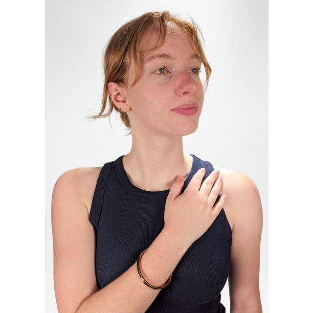 A fine vintage Kawaii bracelet. By Hermes Paris. In rose-tinted gold plate. With a square in the middle emblazoned with...