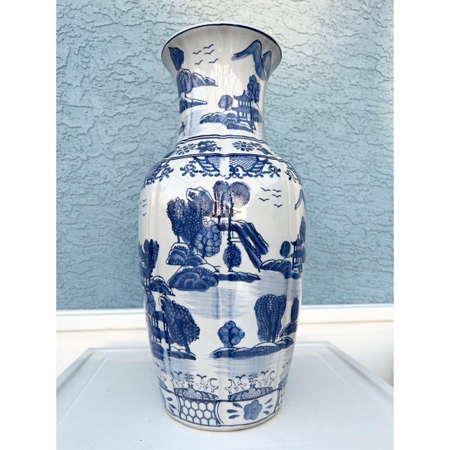This item is a decorative Chinese blue and white porcelain vase featuring traditional hand-painted asian landscape scenes....