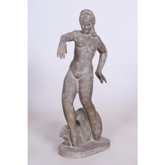 This elegant ceramic statue is a representative example of Czechoslovak Art Deco from the 1920s. It represents a period...