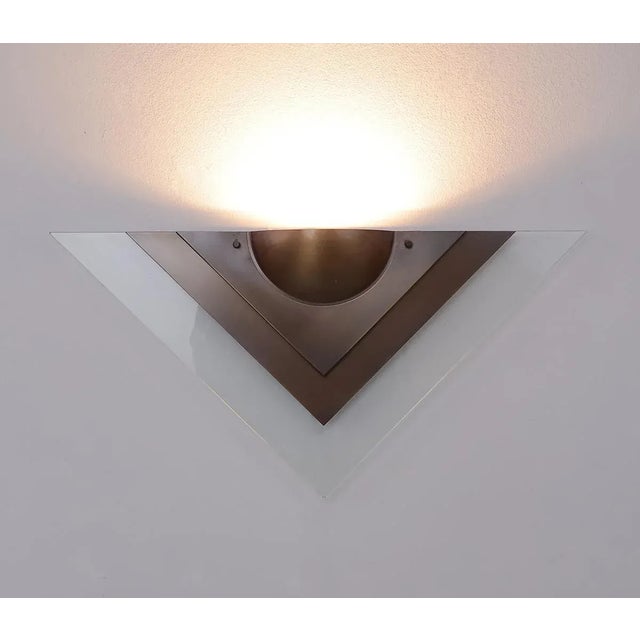Large wall lamp produced by dijkstra lamps in the 1980s. model: triton. this triangular lamp is made of layers of brushed...