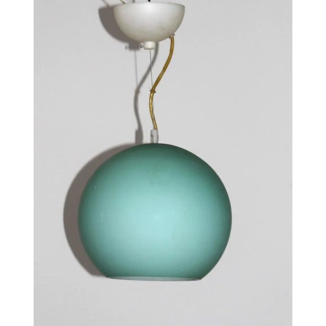 Round glass ball made of thick matted turquoise glass. Italy around 1970. A base E27 Up to 250V (Europe/UK Standard).The...