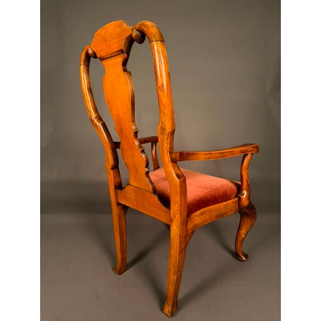 An exceptional pair of late 19th-century English Queen Anne-style armchairs, beautifully crafted and richly detailed,...