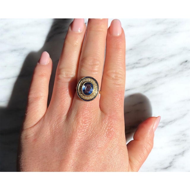 A halo ring from the late Retro period (circa 1960) crafted in 18K yellow gold (750 thousandths). It features an oval...