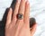 A halo ring from the late Retro period (circa 1960) crafted in 18K yellow gold (750 thousandths). It features an oval...
