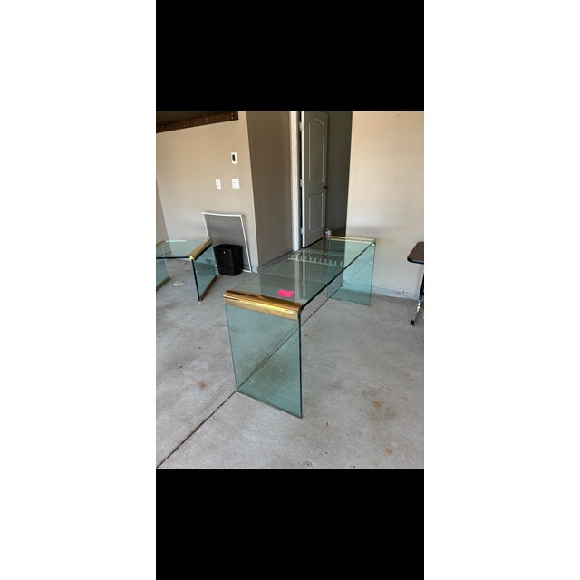 Leon Rosen for Pace Glass and Brass Waterfall Console Table. This elegant piece is a mid-century modern glass classic...