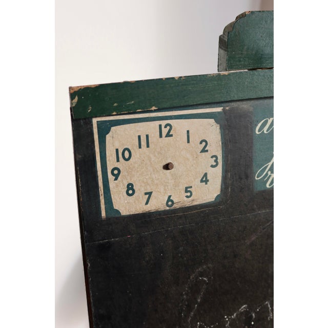 Antique French school blackboard in dark green painted wood, with handwritten alphabet, educational clock, and original...