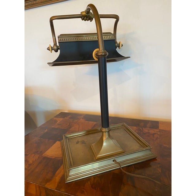 Vintage banker's lamp, featuring a distinctive design with a brass "hand" detail at the top of the shade. Shade is...