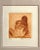 This etching is signed and numbered by the artist. A female nude sits with her back to us, in varying shades of sepia...