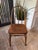 Windsor-style wooden bow back accent chair with turned spindles, a saddle seat and turned spindle legs. Made of solid wood.
