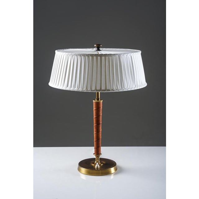 Elegant table lamp model 32926 produced by nordiska kompaniet in the 1940s. The lamp features a refined combination of...