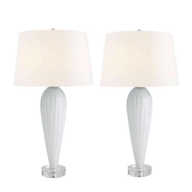 New in box pair of Global Views Teardrop Glass Table Lamps in white. These elegant lamps feature a sculptural ribbed glass...