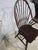 Classic vintage Windsor bow back armchair crafted from solid hardwood with a rich dark finish. This elegant chair features...